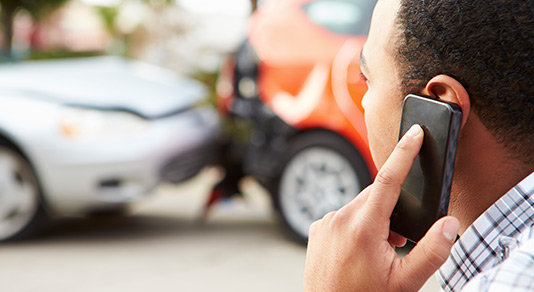 Man on mobile phone after an accident