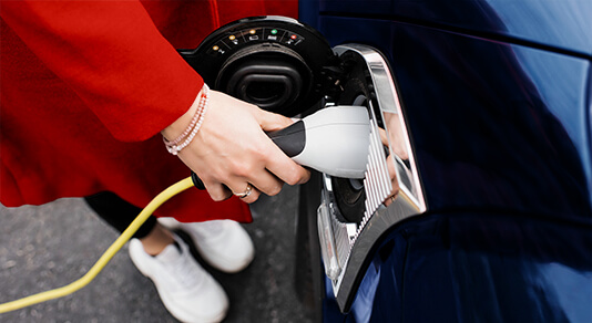 A person charging an electric car