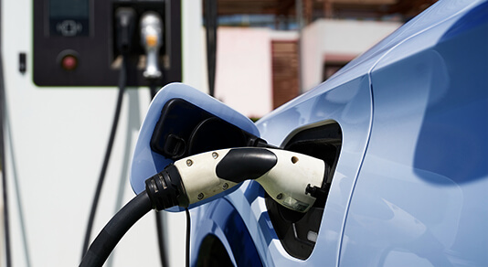 Electric car charging up by a charging station