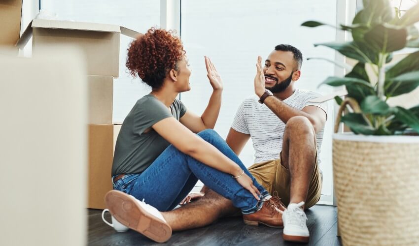 https://www.caasco.com/-/media/caasco/blog/insurance/2020/06/articles/7-insurance-facts-every-first-time-homebuyer-should-know/blog-img--young-couple-high-fiving-each-other-while-sitting-on-floor-surrounded-by-packing-boxes.jpg